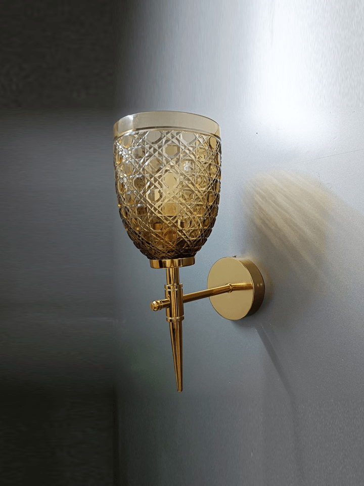 Elegant gold PVD sitting room wall sconce with sparkling, hand-cut champagne glass.