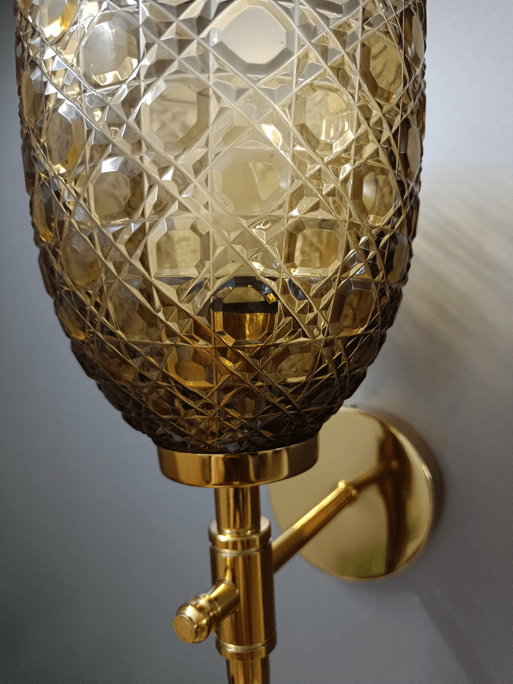 Luxuriate in the beauty of hand-cut champagne glass with this gold PVD wall lamp, perfect for sitting room lighting.