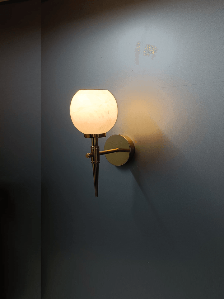 Elegant wall light: gold PVD finish & natural marble shade (India).