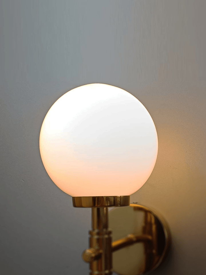 Ice ball light on the wall! Gold PVD sconce with a frosted opal glass ball for a unique look.