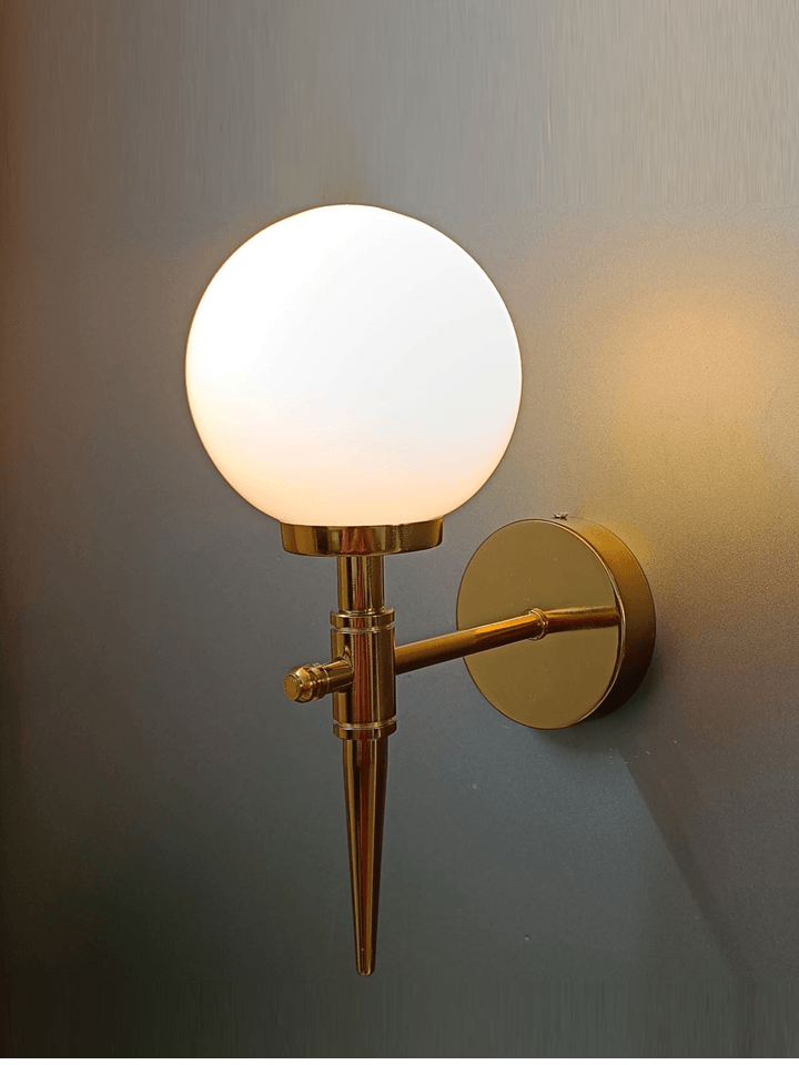 Frosted opal glass ball wall light in gold PVD, perfect for adding a touch of modern luxury.