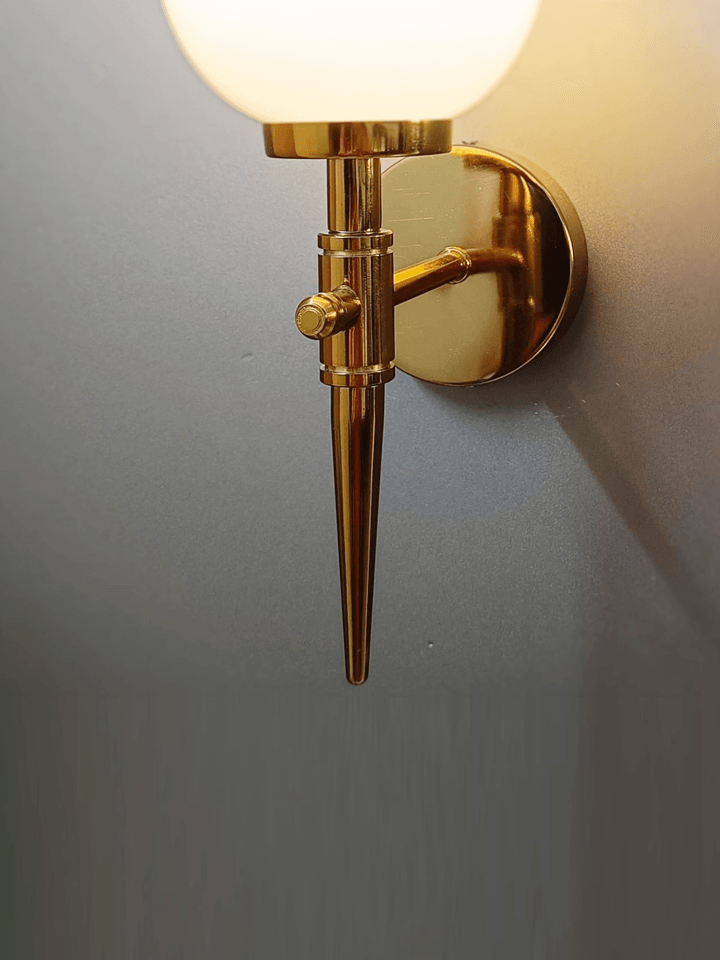 Light up your walls with these gold PVD sconces featuring frosted opal glass balls.