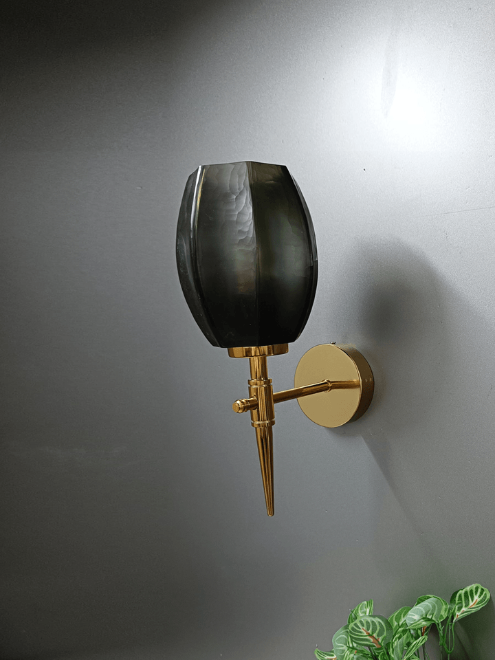 Gold wall light with a unique geometric design (India).