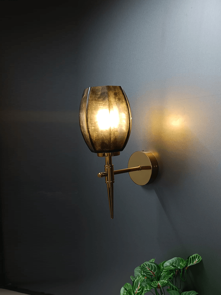 Multiple gold wall lights installed above a living room fireplace.