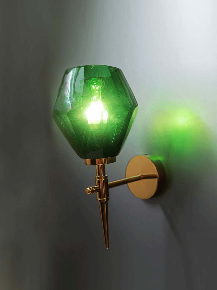 Green crystal wall light casting a sparkling light pattern on a wall. (Keywords: wall lights for home, green crystal wall light, light pattern)