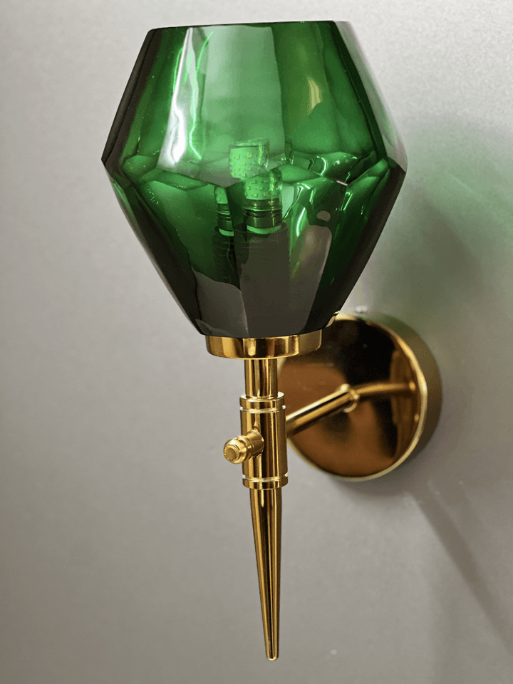 Green crystal wall light casting a soft glow on a reading nook. (Keywords: wall lights for home, green crystal wall light, reading nook)