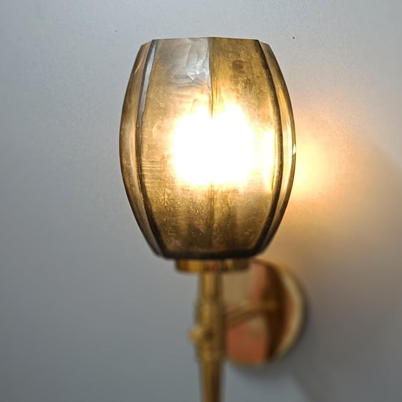 Modern gold living room wall light with warm, inviting glow.