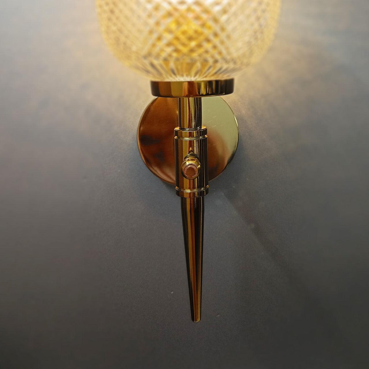 Elegant gold PVD bedroom wall sconce with sparkling, hand-cut crystal glass.