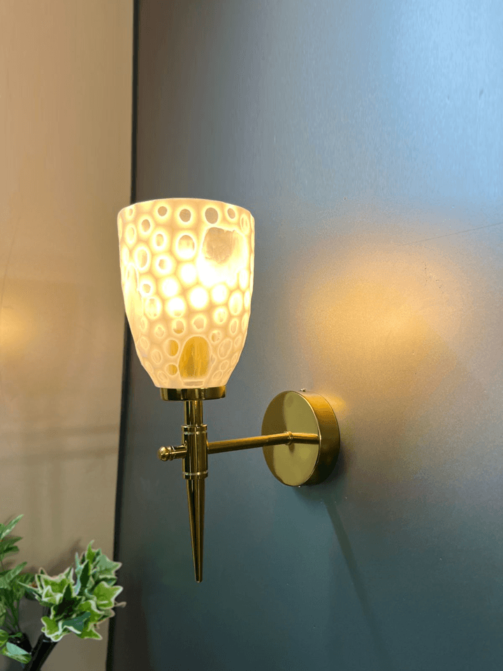 Luxurious gold PVD fancy wall sconce with sparkling crystal shade. 