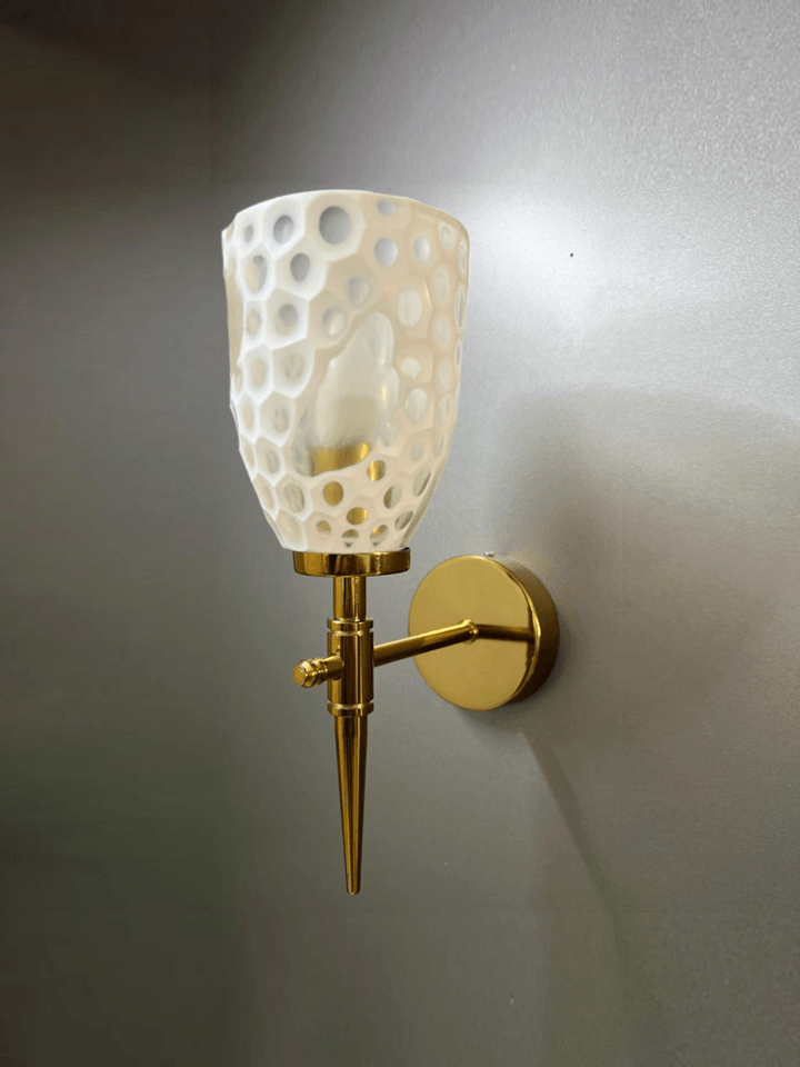 Modern luxury wall sconce in gold PVD finish with crystal glass.  pen_spark