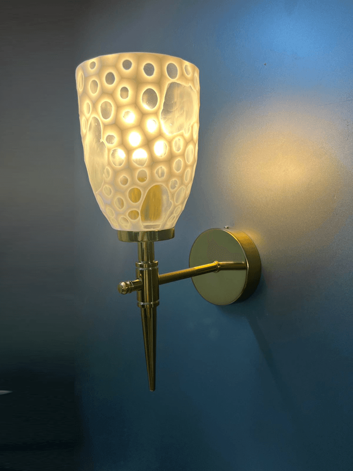 Glamorous gold PVD wall sconce featuring a dazzling crystal glass shade. 