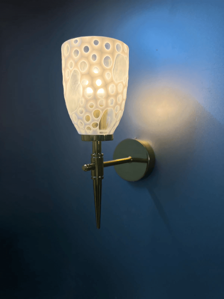 Handcrafted Indian gold PVD wall lamp with a modern crystal glass design.  pen_spark