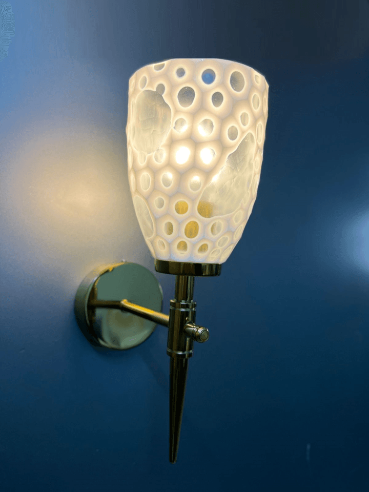 Handcrafted in India, gold PVD fancy wall sconce for modern decor.  pen_spark