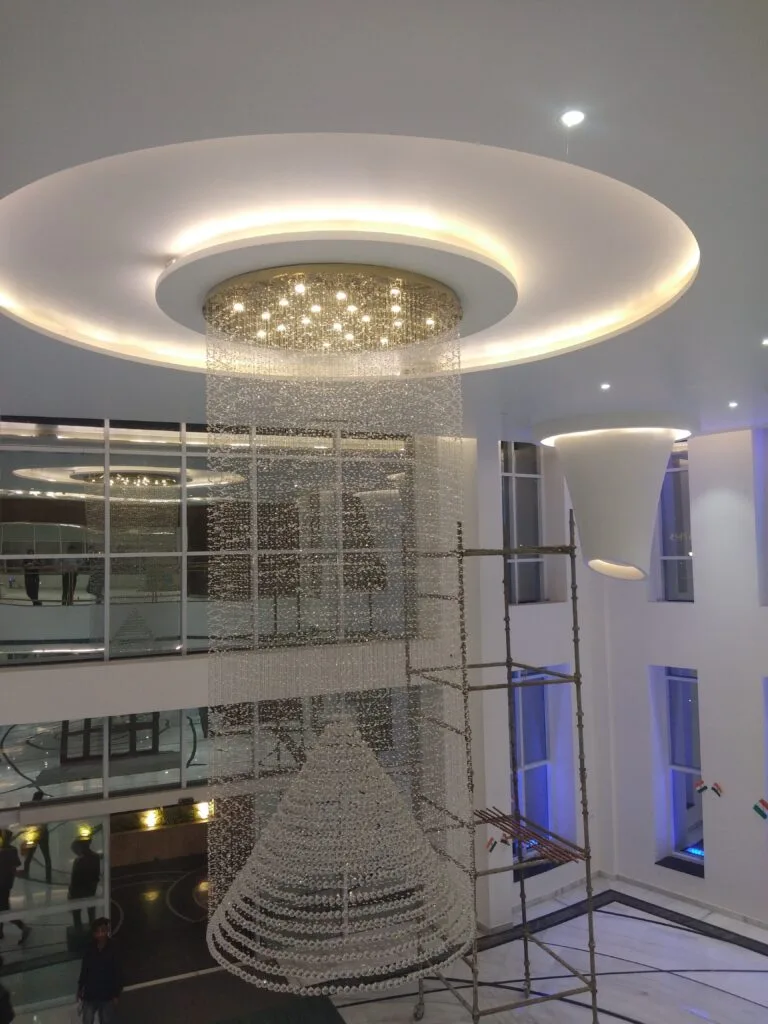 Large crystal chandelier with inner cone form in the Purvanchal Royal City clubhouse
