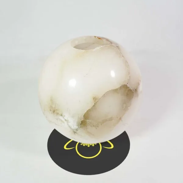 Alabaster ball seen from above, showing the round opening that sits over the holder collar