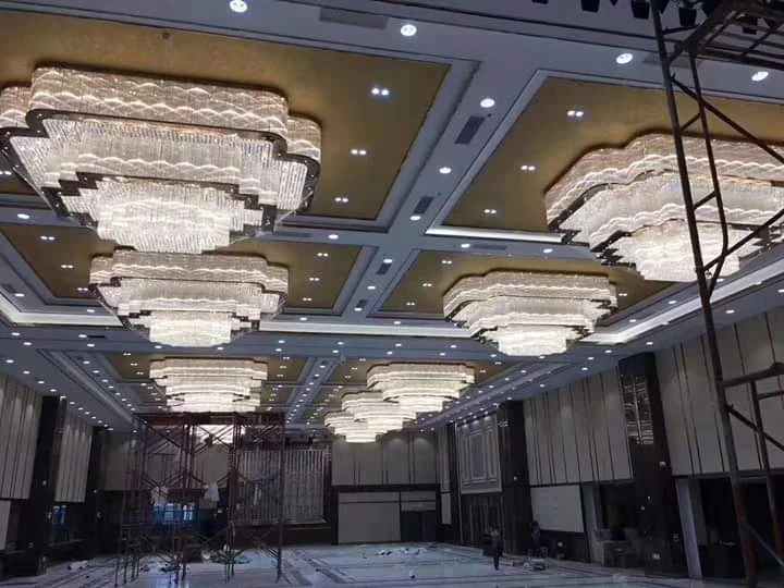 Multiple stepped banquet chandeliers installed across the ceiling at Silver Oak Hotel and Banquet Kanyakumari