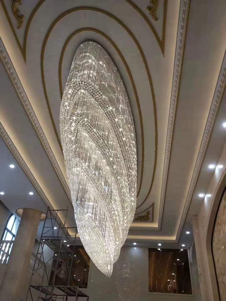 Long tapered crystal lobby chandelier viewed from below in the Rajmahal Jaipur project