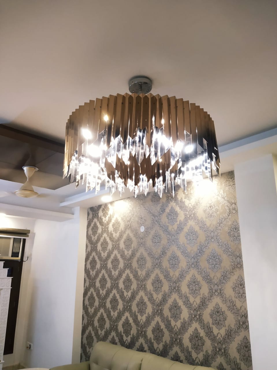 Three-foot round chandelier installed over the residential seating area in the Delhi flat