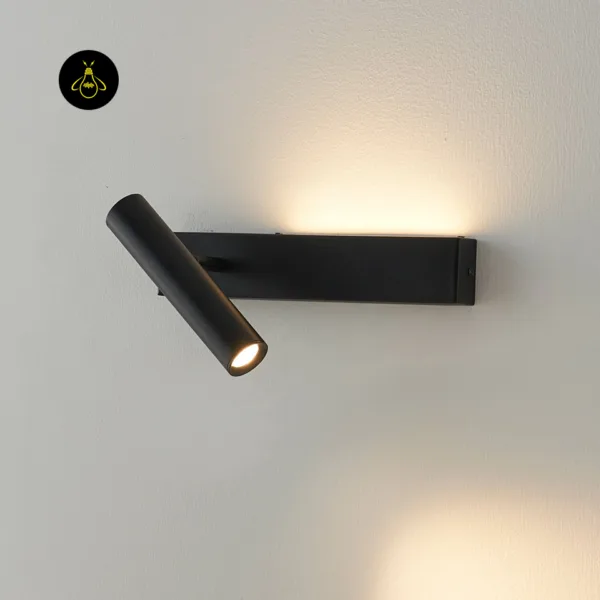 Black stainless steel wall reading lamp lit, with warm light washing up and down a white wall