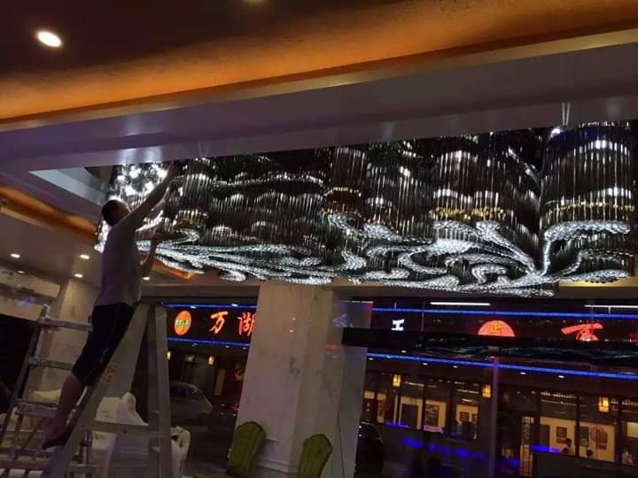 Installation-stage underside of the banquet chandelier at Topaz Radiance Surat
