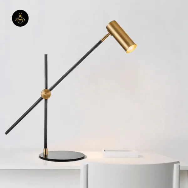 Adjustable brass desk lamp angled over a desk for focused task lighting