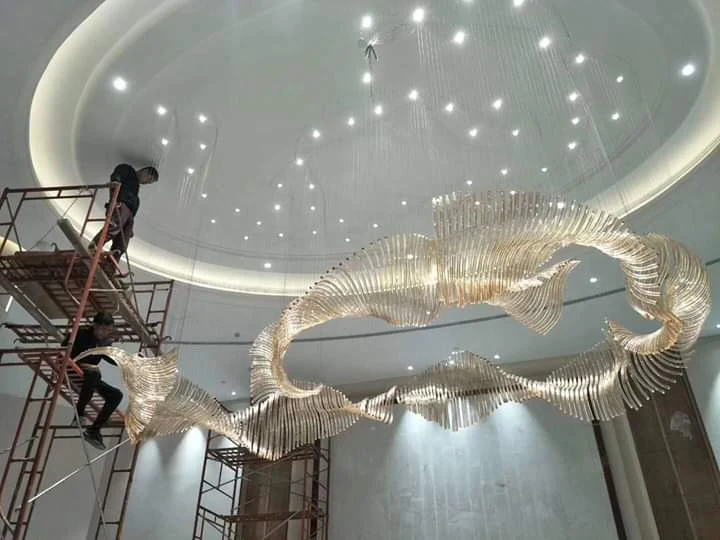 Installation team working beside the 18-foot crystal chandelier at Grand Howrah Banquets Kolkata