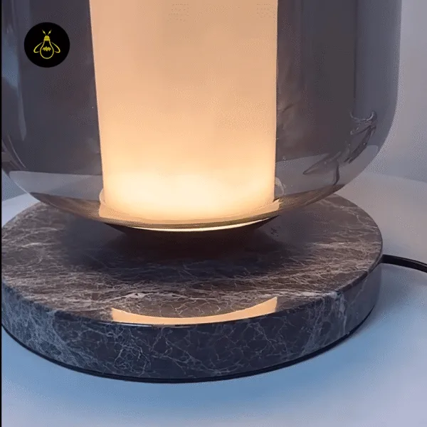 Two-tier black marble base of the smoked borosilicate glass table lamp, close-up