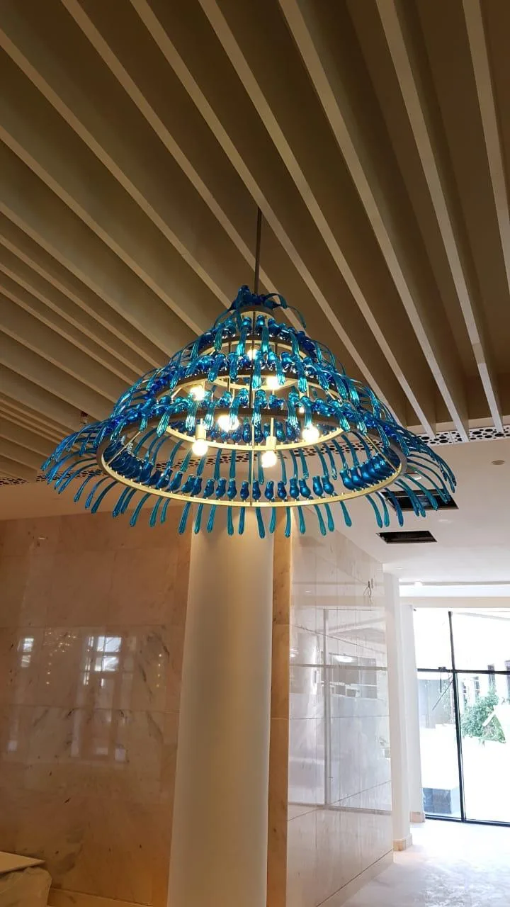 Blue borosilicate glass bird chandelier detail in the Hyatt Regency project