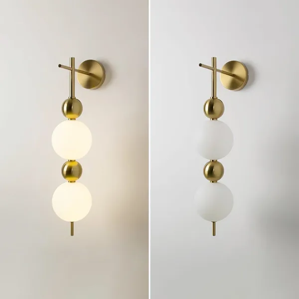 Bedside wall light shown lit and unlit side by side, brushed-brass stem with two opal borosilicate glass globes