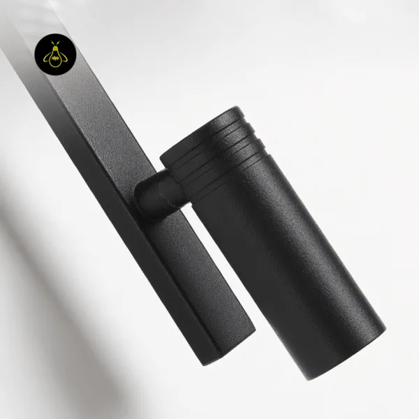 Close-up of the textured matte black stainless steel reading spot and swivel joint on the wall mounted study lamp