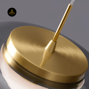 Close-up of the brushed gold cap on a smoky glass pendant light