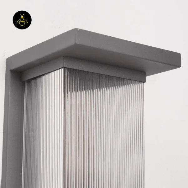 Close-up of the entrance light’s textured charcoal grey stainless steel canopy above the ribbed clear acrylic diffuser