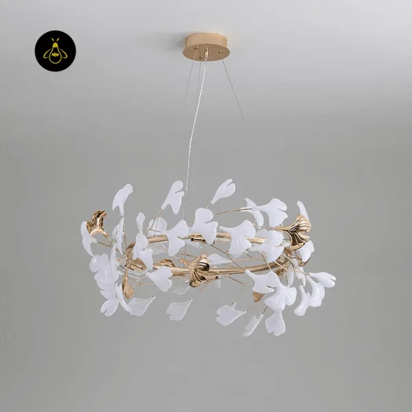 Close-up of hand-glazed ceramic ginkgo leaves on a gold leaf chandelier