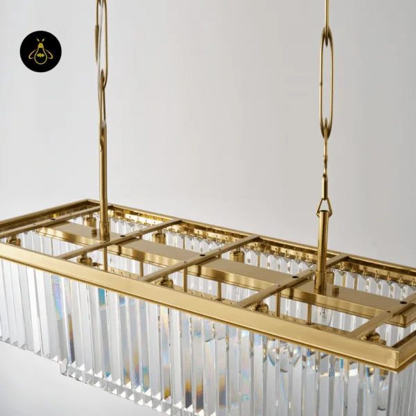 Close-up of clear faceted crystal prisms on a satin gold crystal chandelier