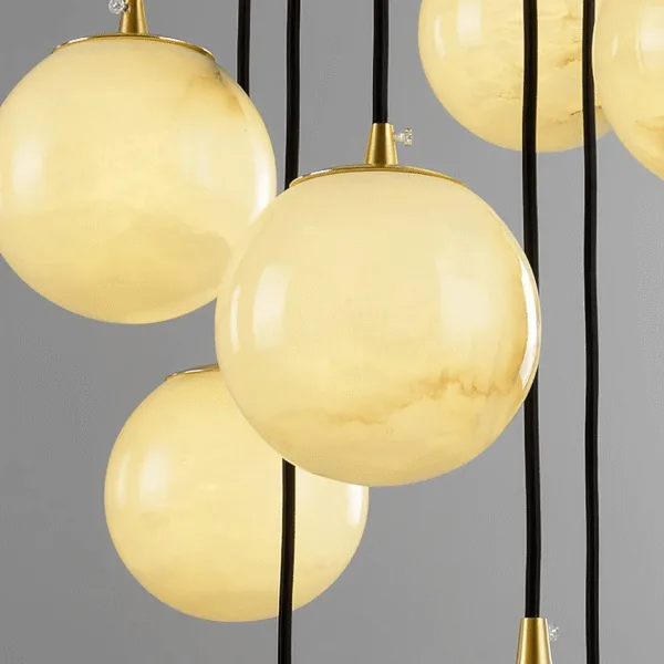 Close-up of genuine alabaster orbs with natural veining glowing warm on the alabaster ball chandelier