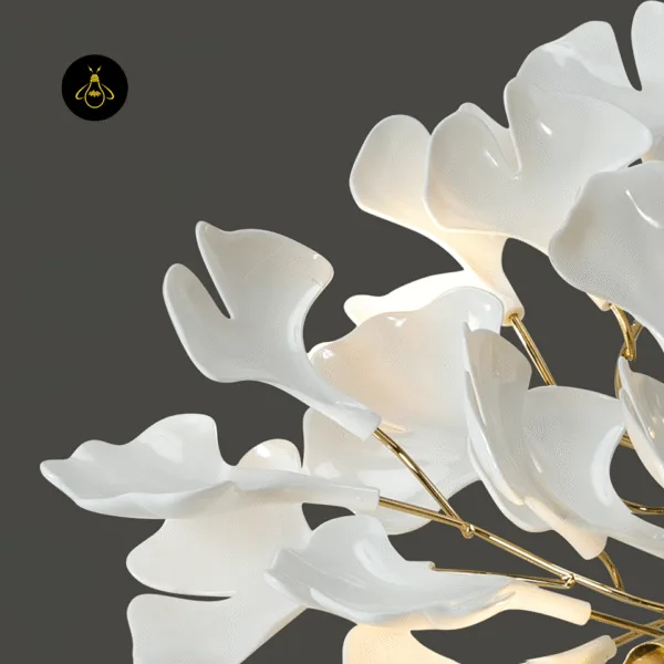 Close-up of glazed white ceramic ginkgo leaves on the brass branch ceramic leaf chandelier