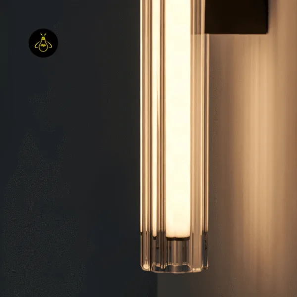 Close-up of the clear fluted borosilicate glass tube and lit opal inner diffuser of the LED wall lamp