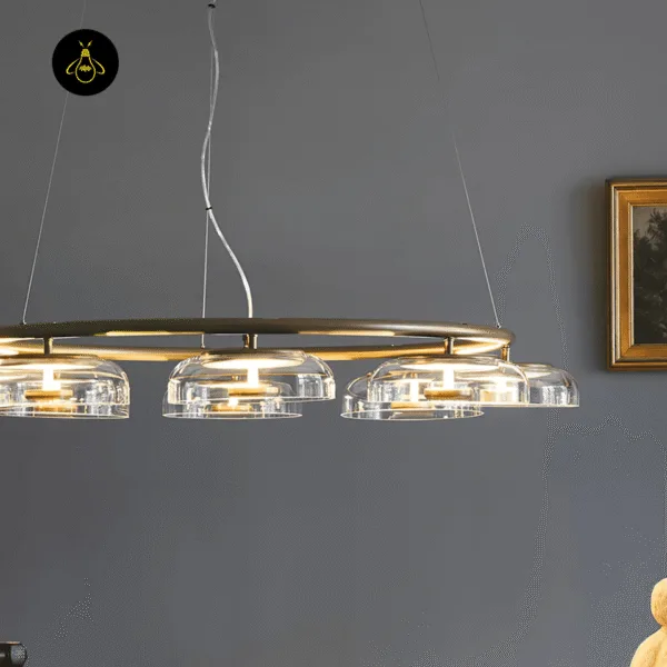 Close-up of a clear mouth-blown glass dome shade on the brass chandelier