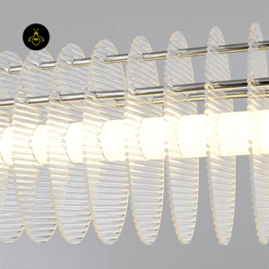 Close-up of clear acrylic discs on a linear LED chandelier diffusing warm light