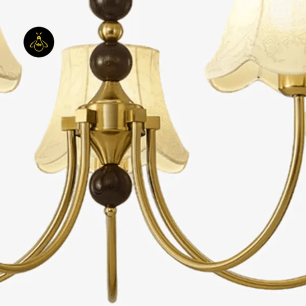 Close-up of ivory fabric shade and walnut wood spheres on the gold fabric shade chandelier