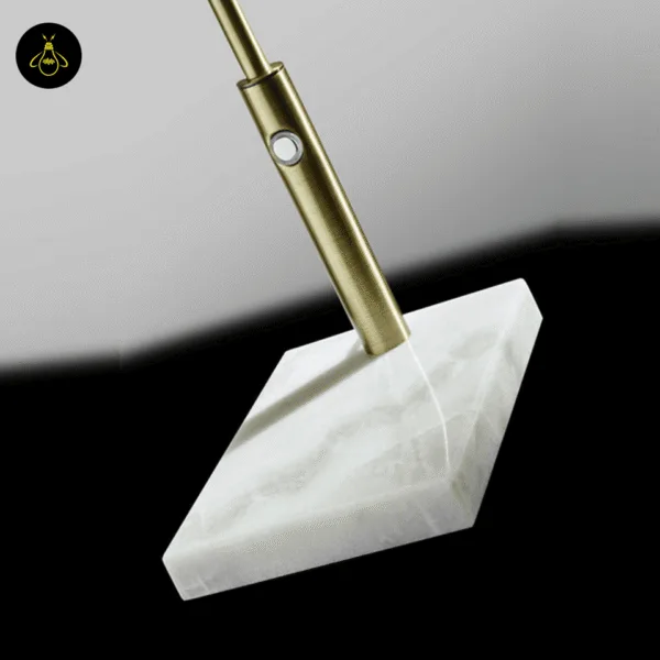 Push-button dimmer switch on the antique brass marble desk lamp stem