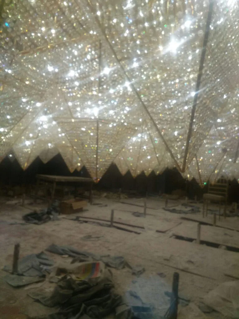 Large gold-framed custom crystal ceiling structure under installation at Zestin Luminary Sahibabad