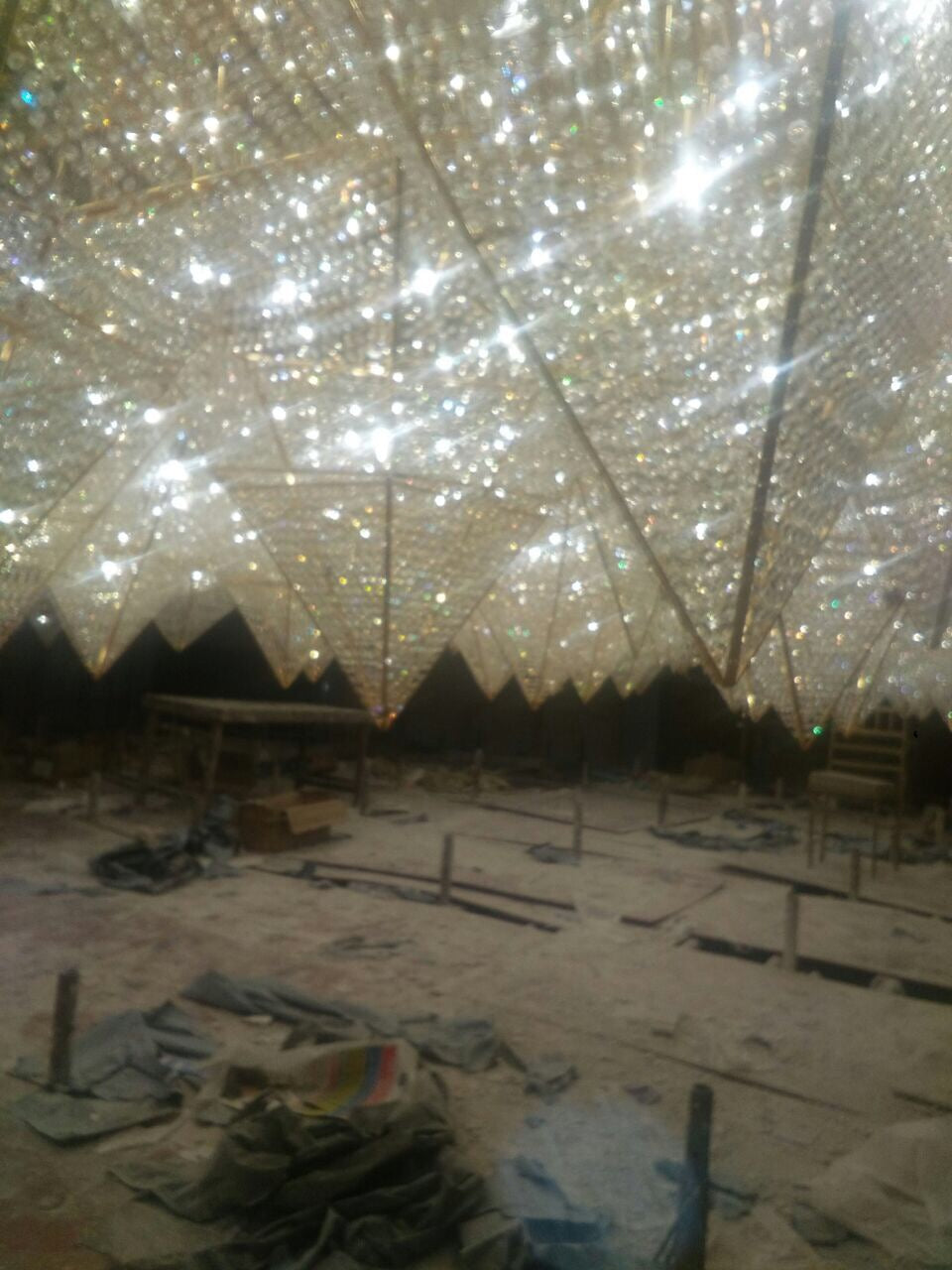 Large gold-framed custom crystal ceiling structure under installation at Zestin Luminary Sahibabad