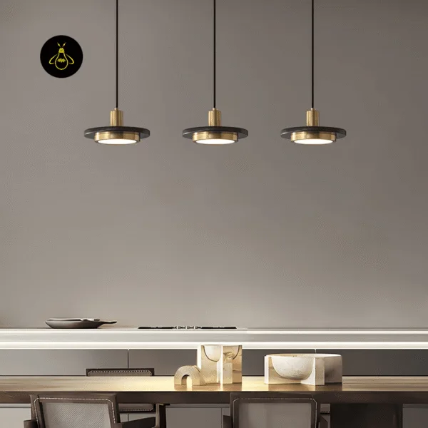 Three black marble pendant lights in a row over a dining table