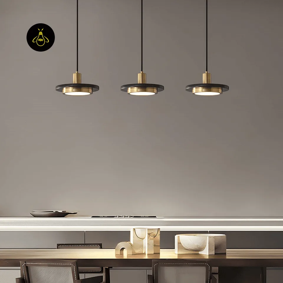 Black Marble Pendant Light – Double Circle Gold LED Drum, 20 cm 4 Three black marble pendant lights in a row over a dining table