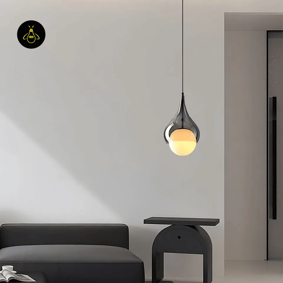 Smoked Glass Teardrop Pendant Light – 20 cm Hanging Bedside Light with Opal Globe 4 Hanging bedside light in smoked borosilicate glass hung beside a sofa and side table in a modern living room