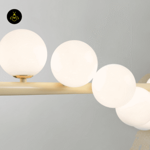 Creamy yellow metal finish of the linear glass ball chandelier bar