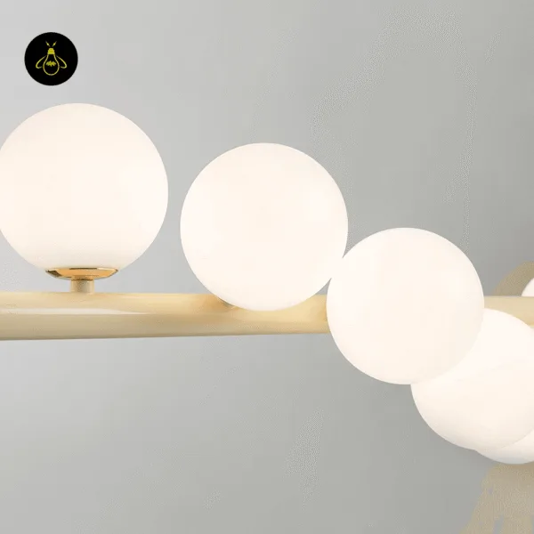 Creamy yellow stainless steel finish of the linear glass ball chandelier bar