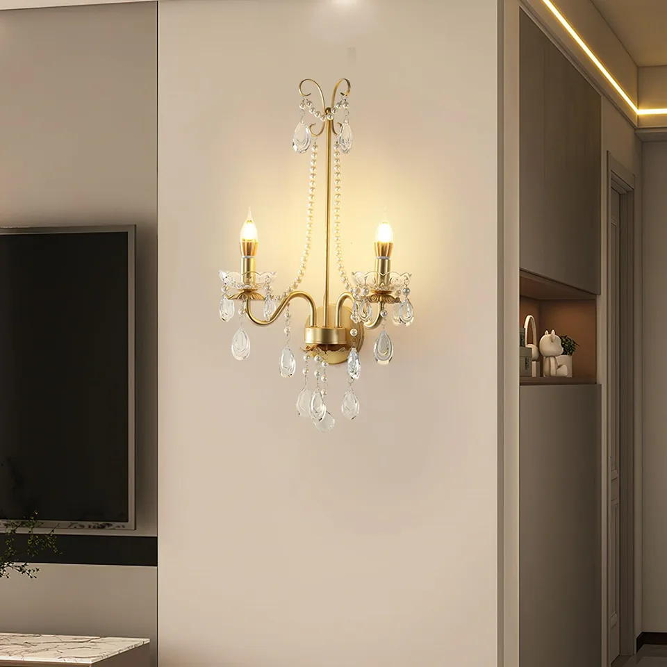 Gold Crystal Wall Sconce – 2-Light Pearl Chain French Sconce, 64 cm 4 Gold crystal wall sconce lit with warm candle glow in a modern living room