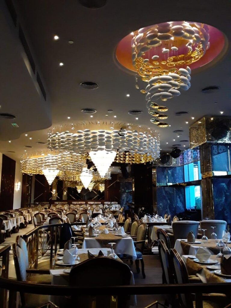 Restaurant ceiling installation in Hyderabad with egg-shell forms and crystal cone chandeliers